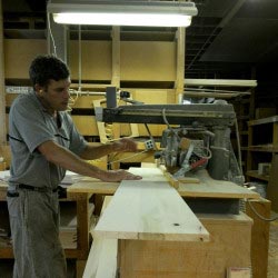Rojahn Cabinet Maker in Shop Cutting Wood